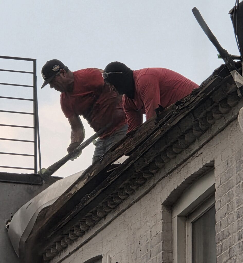 The crew spreading asbestos in the air with improper roof removal.